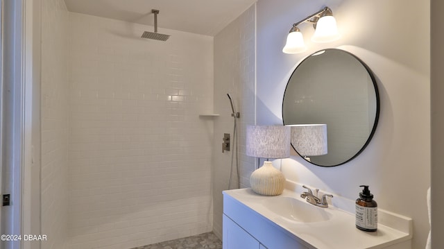 bathroom with vanity and tiled shower