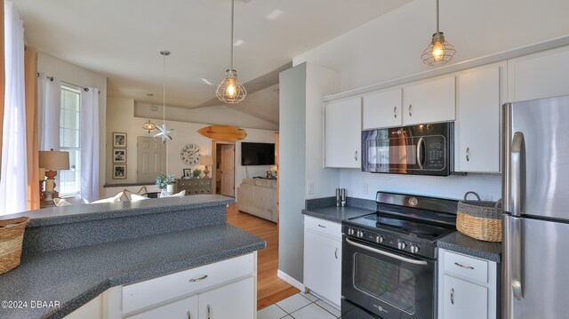 kitchen featuring black appliances, tasteful backsplash, white cabinetry, pendant lighting, and light hardwood / wood-style floors