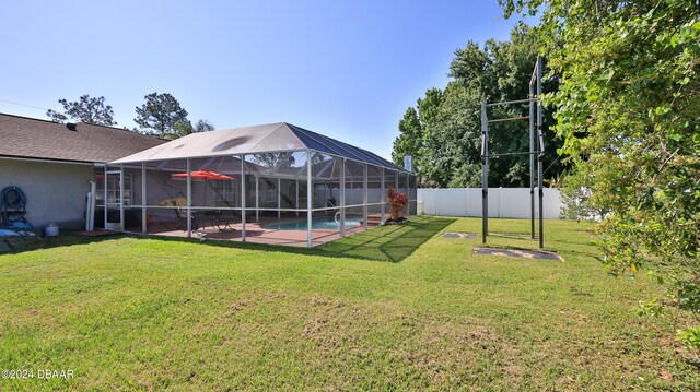 view of yard with a lanai and a fenced in pool