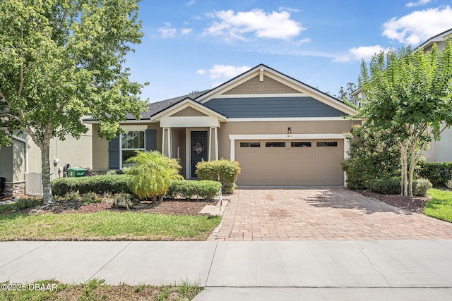 2412 Regency Park Dr, Deland, FL 32724 - view of front of house featuring decorative driveway, a garage, and stucco siding
