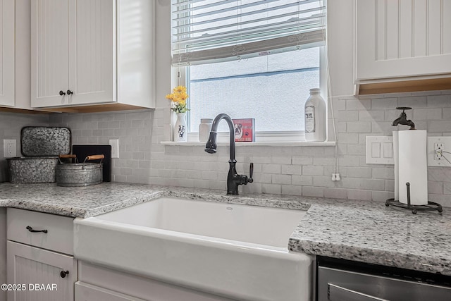 2412 Regency Park Dr, Deland, FL 32724 - kitchen featuring a sink, decorative backsplash, white cabinets, light stone counters, and dishwasher