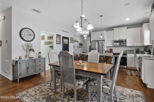 2412 Regency Park Dr, Deland, FL 32724 - dining area with dark wood-style floors, recessed lighting, and a chandelier