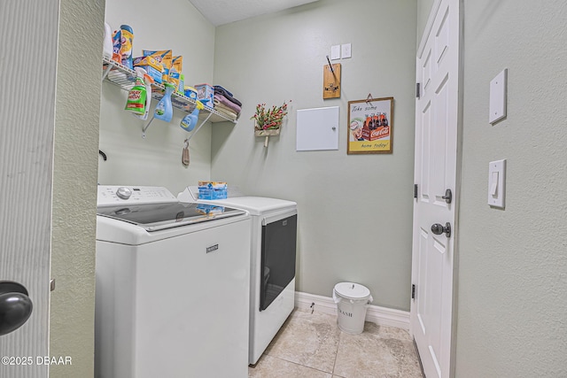 2412 Regency Park Dr, Deland, FL 32724 - laundry room featuring separate washer and dryer, light tile patterned floors, and baseboards