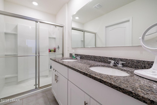58 Bella Oaks Dr, Port Orange, FL 32129 - bathroom with a shower stall, double vanity, tile patterned floors, and recessed lighting