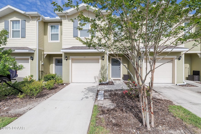 58 Bella Oaks Dr, Port Orange, FL 32129 - view of property with driveway, a garage, stucco siding, and roof with shingles