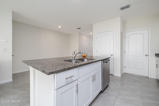 58 Bella Oaks Dr, Port Orange, FL 32129 - kitchen with dishwasher, dark stone counters, light tile patterned flooring, white cabinets, and an island with sink