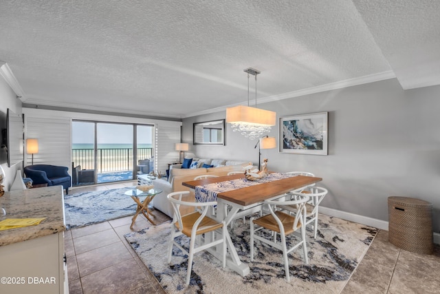 5499 S Atlantic Ave, New Smyrna Beach, FL 32169 - dining room with ornamental molding, a textured ceiling, light tile patterned floors, and a water view