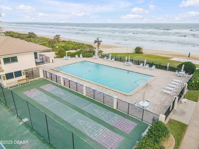 5499 S Atlantic Ave, New Smyrna Beach, FL 32169 - community pool featuring shuffleboard, view of water and beach, and a patio area