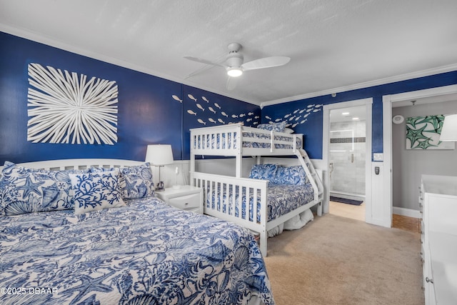 5499 S Atlantic Ave, New Smyrna Beach, FL 32169 - bedroom with ornamental molding, carpet floors, connected bathroom, ceiling fan, and a textured ceiling