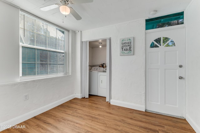 foyer with light wood finished floors, baseboards, washing machine and clothes dryer, ceiling fan, and a textured wall