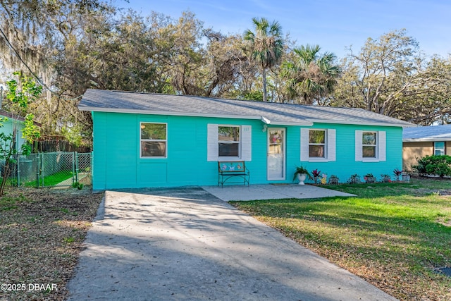 view of front of property with a gate, driveway, a front yard, and fence