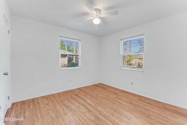 empty room with baseboards, light wood-style floors, and a ceiling fan