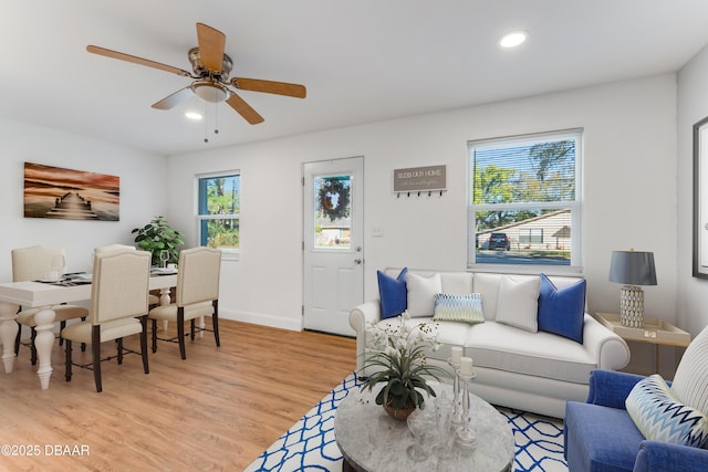 living area with recessed lighting, a healthy amount of sunlight, and light wood-style flooring