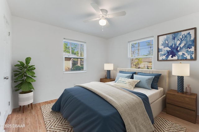 bedroom with light wood-style flooring and ceiling fan