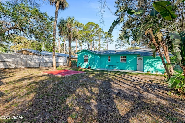 back of house with fence