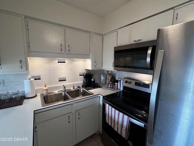 kitchen with sink, white cabinets, and appliances with stainless steel finishes