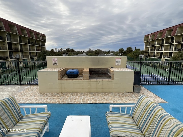 view of pool with outdoor lounge area and area for grilling