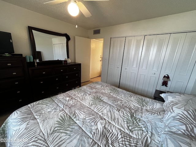 bedroom with a textured ceiling, a closet, and ceiling fan