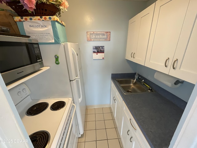 kitchen featuring light tile patterned flooring, sink, white cabinetry, and white electric stove