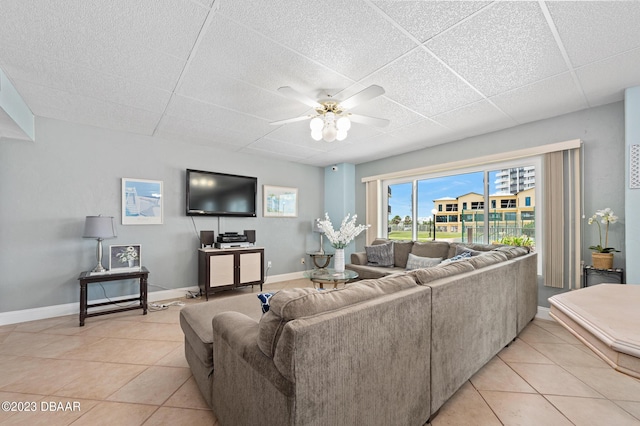 3600 S Ocean Shore Blvd # 111, Flagler Beach, FL 32136 - living area featuring a ceiling fan, a drop ceiling, baseboards, and light tile patterned flooring