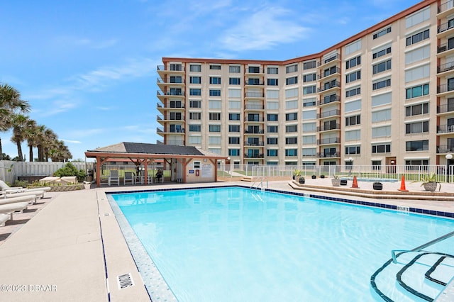 3600 S Ocean Shore Blvd # 111, Flagler Beach, FL 32136 - pool featuring a gazebo, fence, and a patio area