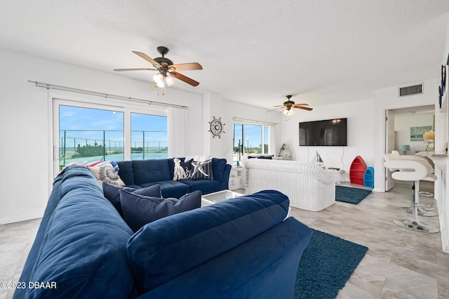 3600 S Ocean Shore Blvd # 111, Flagler Beach, FL 32136 - living area with a textured ceiling, a ceiling fan, and visible vents