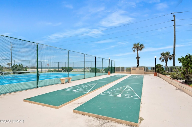 3600 S Ocean Shore Blvd # 111, Flagler Beach, FL 32136 - surrounding community with shuffleboard, a tennis court, and fence