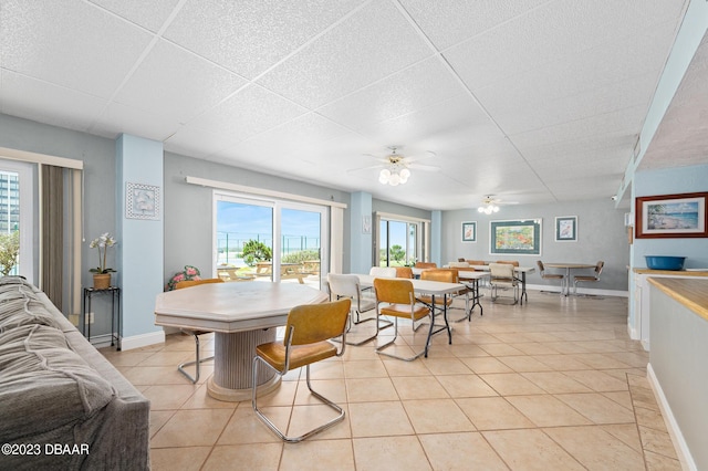 3600 S Ocean Shore Blvd # 111, Flagler Beach, FL 32136 - dining room with baseboards, ceiling fan, and light tile patterned flooring