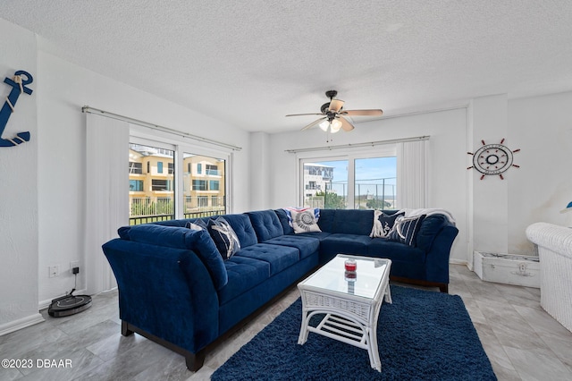 3600 S Ocean Shore Blvd # 111, Flagler Beach, FL 32136 - living room featuring a textured ceiling, baseboards, and a ceiling fan