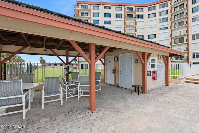 3600 S Ocean Shore Blvd # 111, Flagler Beach, FL 32136 - view of patio featuring outdoor dining area and fence