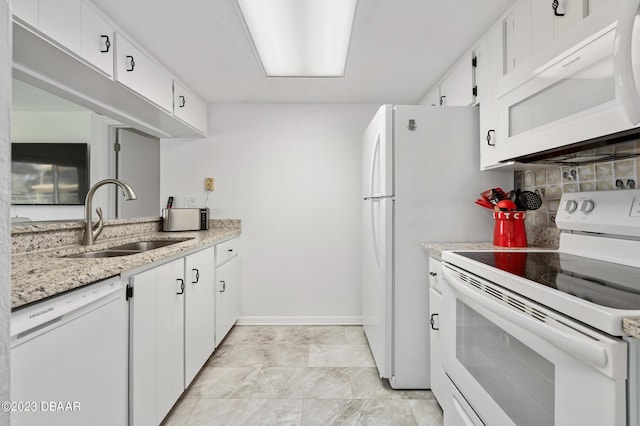 3600 S Ocean Shore Blvd # 111, Flagler Beach, FL 32136 - kitchen with baseboards, white appliances, a sink, white cabinetry, and backsplash