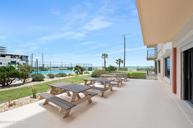3600 S Ocean Shore Blvd # 111, Flagler Beach, FL 32136 - view of patio featuring fence and a tennis court
