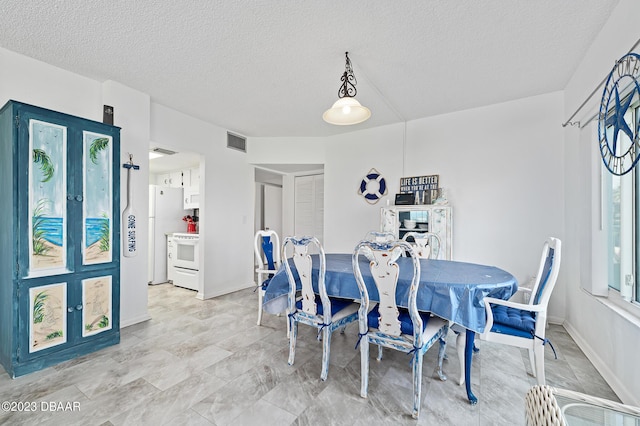3600 S Ocean Shore Blvd # 111, Flagler Beach, FL 32136 - dining space with a textured ceiling, baseboards, and visible vents