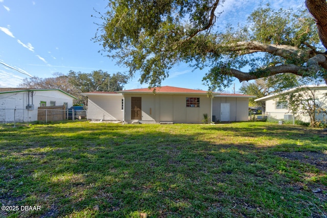 rear view of house with a lawn