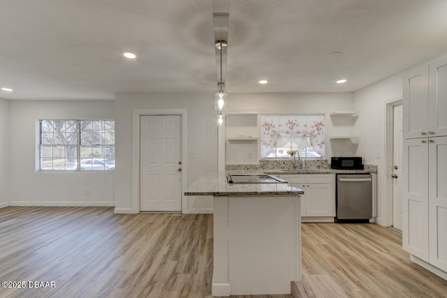 kitchen featuring pendant lighting, light stone counters, black appliances, white cabinets, and light wood-type flooring