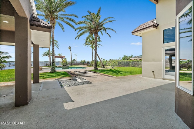 view of patio / terrace featuring fence and an outdoor pool