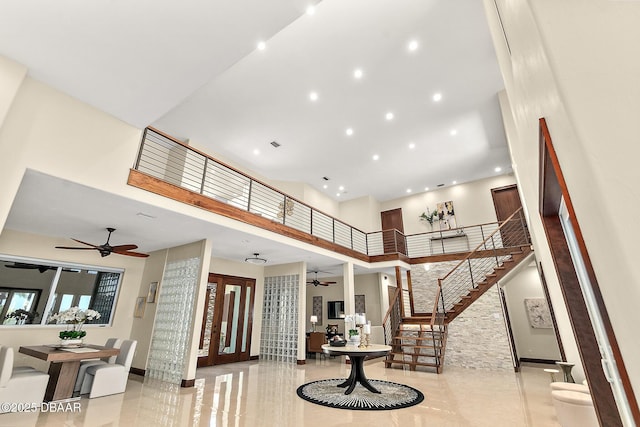 foyer entrance with stairs, recessed lighting, a high ceiling, and ceiling fan
