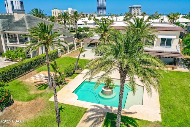 outdoor pool featuring a lawn and fence