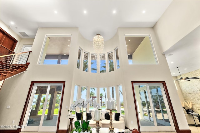living room featuring recessed lighting, a high ceiling, and french doors