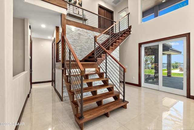 stairs featuring tile patterned flooring, recessed lighting, and baseboards