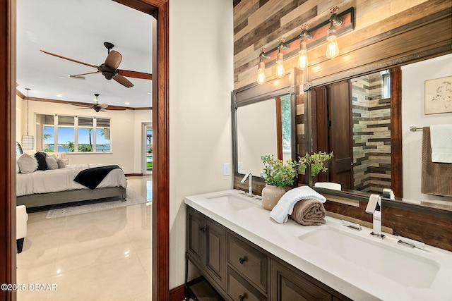 full bath with a sink, tile patterned flooring, a ceiling fan, and ensuite bath
