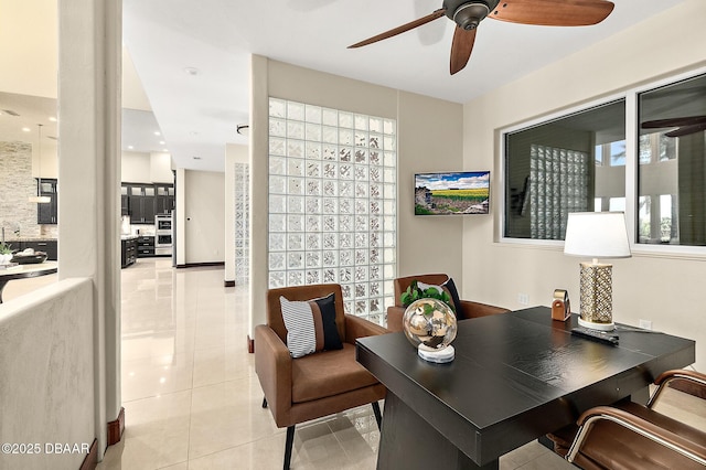 office featuring light tile patterned floors and ceiling fan