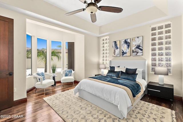 bedroom with baseboards, ceiling fan, and wood finished floors