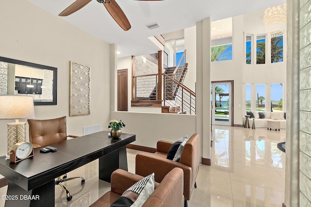 home office with visible vents, a ceiling fan, baseboards, and light tile patterned floors