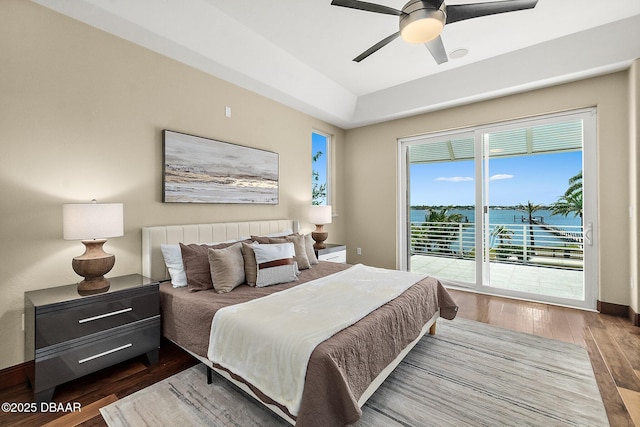 bedroom featuring a ceiling fan, wood finished floors, and access to exterior