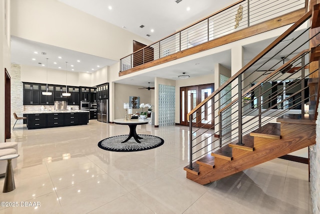 entryway with visible vents, a high ceiling, stairway, recessed lighting, and light tile patterned floors