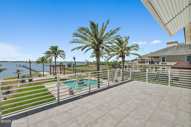 view of patio with a water view and a swimming pool