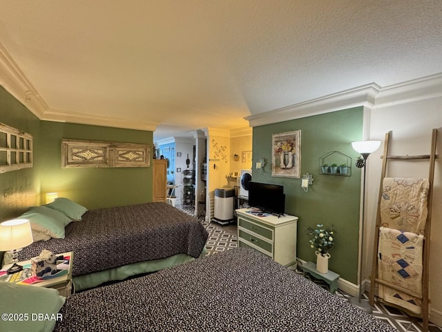 bedroom with a textured ceiling, baseboards, and ornamental molding