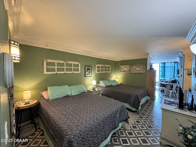 bedroom featuring a textured ceiling and ornamental molding