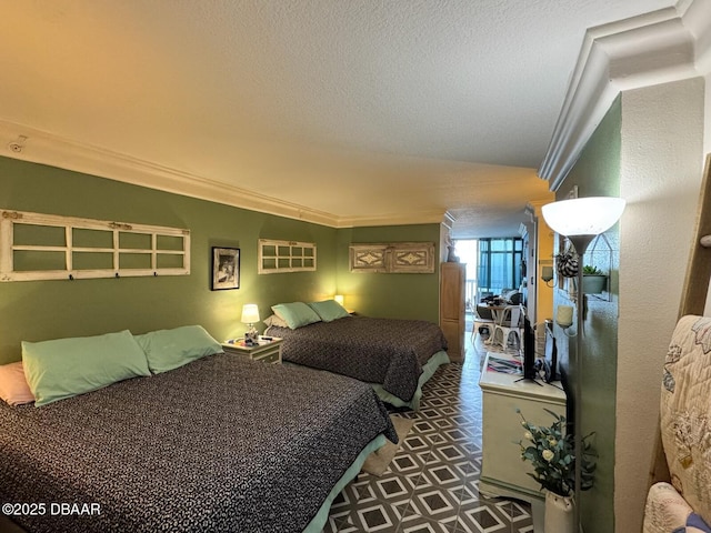 bedroom with tile patterned floors, a textured ceiling, and ornamental molding